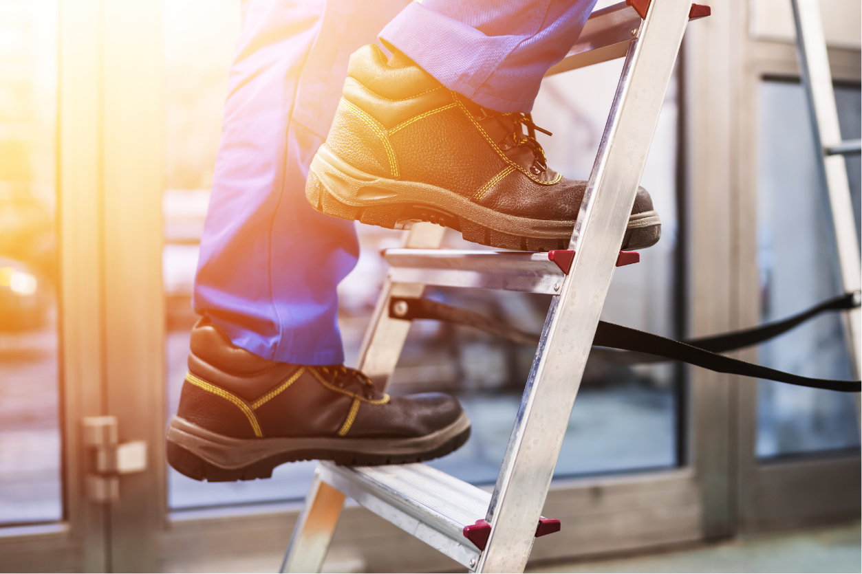 Aluminum ladder blue work pants safety boots indoor climbing large windows NEI Distributors North Reading MA.