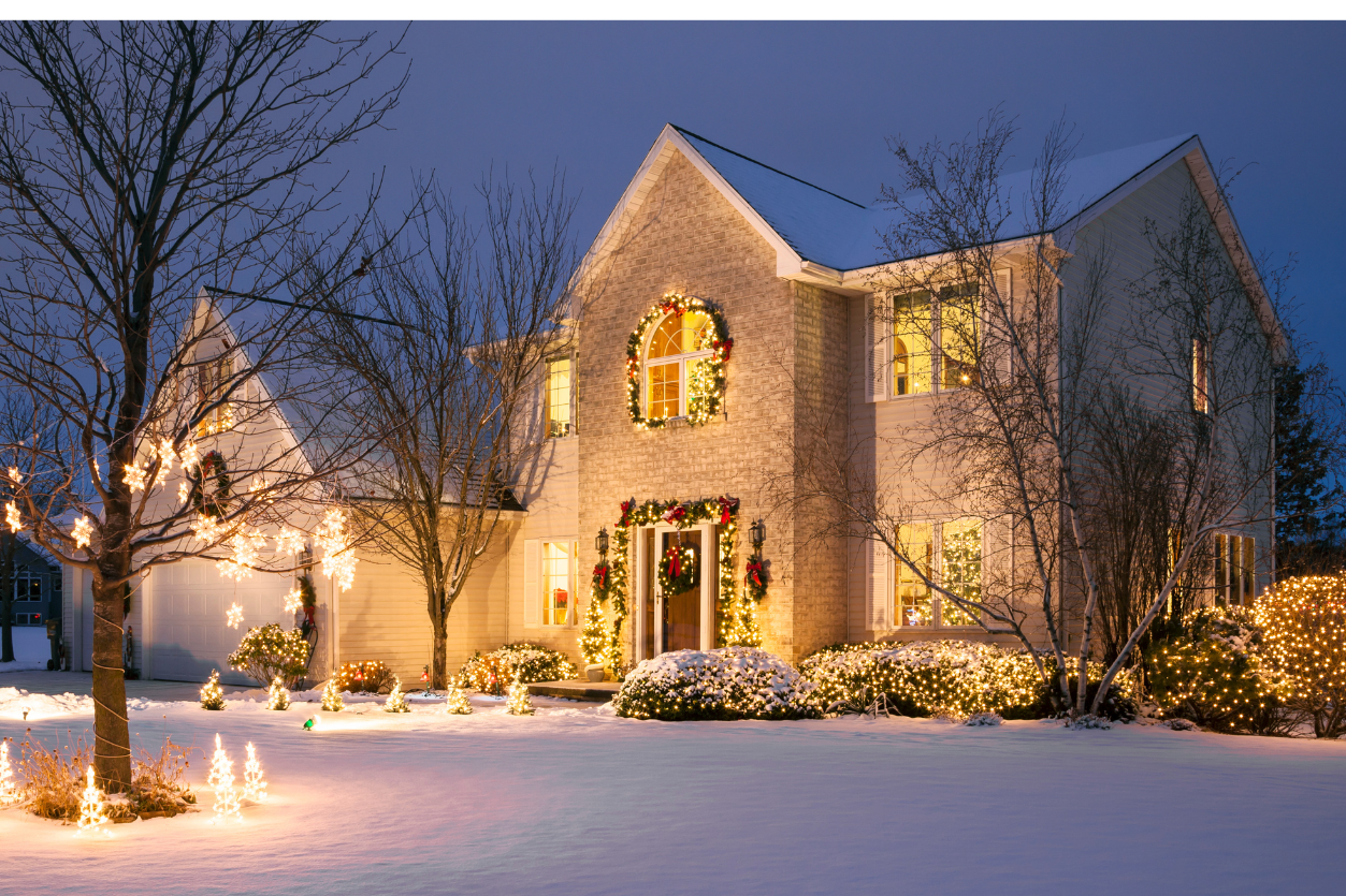 Large white house with festive holiday lights and wreaths NEI Distributors North Reading MA.