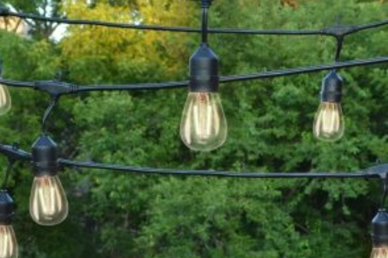 Bistro lighting outdoor string lights warm bulbs green landscaping NEI Distributors North Reading MA.