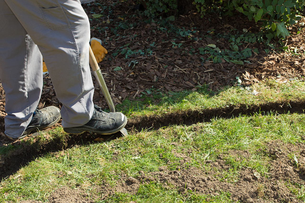 Spade gray pants black shoes garden bed edging clean line NEI Distributors North Reading MA.