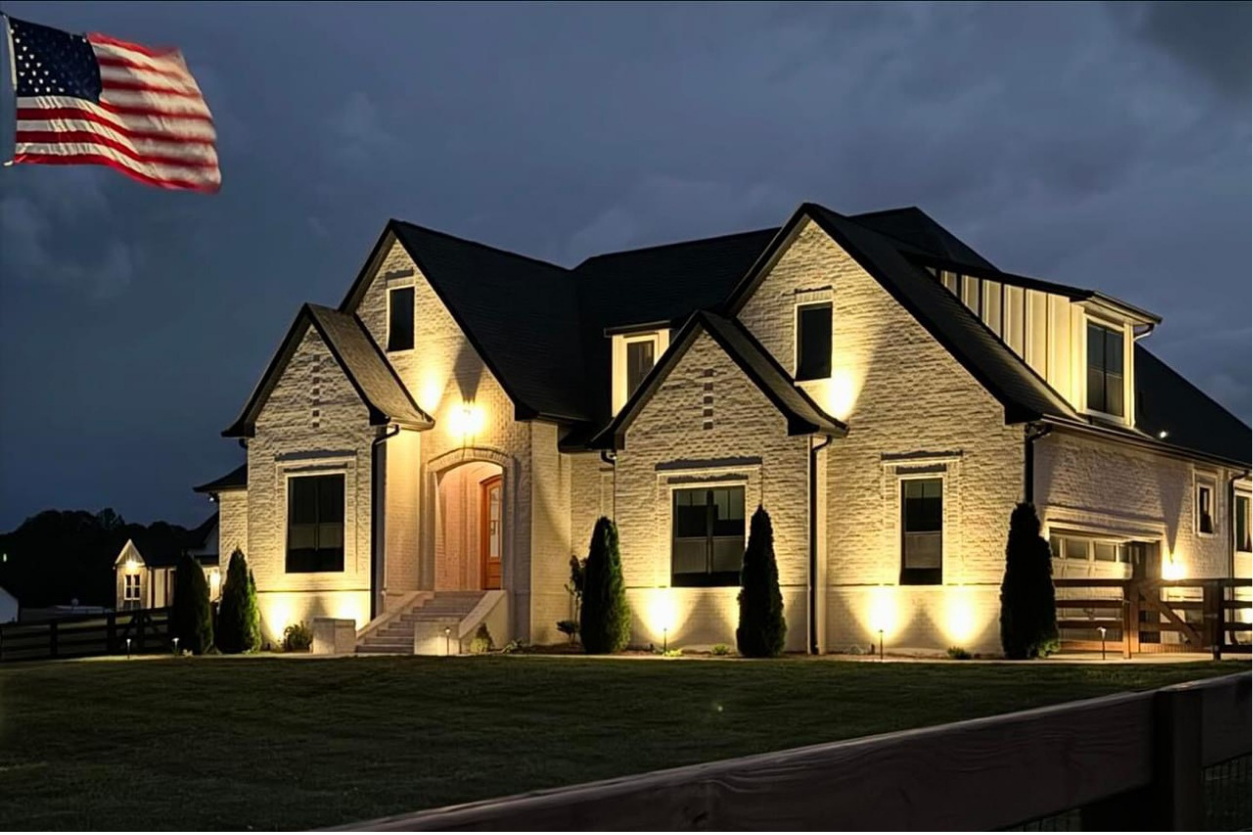 Pro Grade landscape lighting large white two story modern house dusk Wi Fi smart features NEI Distributors North Reading MA.